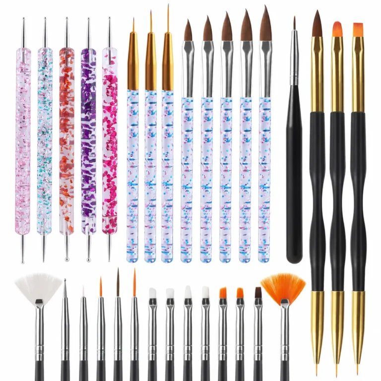 Assortment of dotting tools detail brushes and nail art brushes arranged on a white background